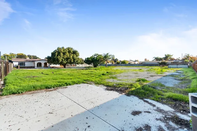 a view of a garden with a building in the background