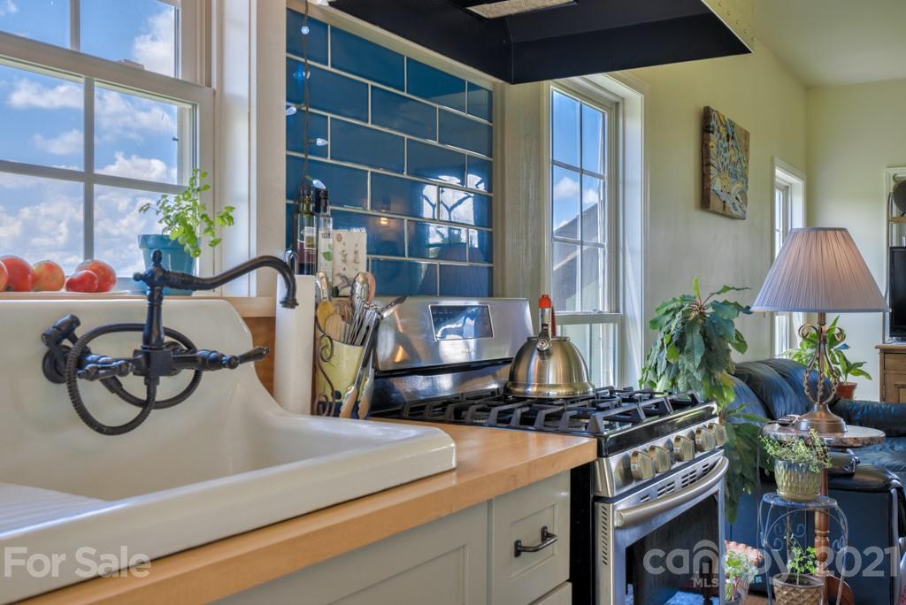 1365 Airport Road Rutherfordton, NC 28139 - Photo 14 of 32 a kitchen with a stove and a white cabinets next to a window