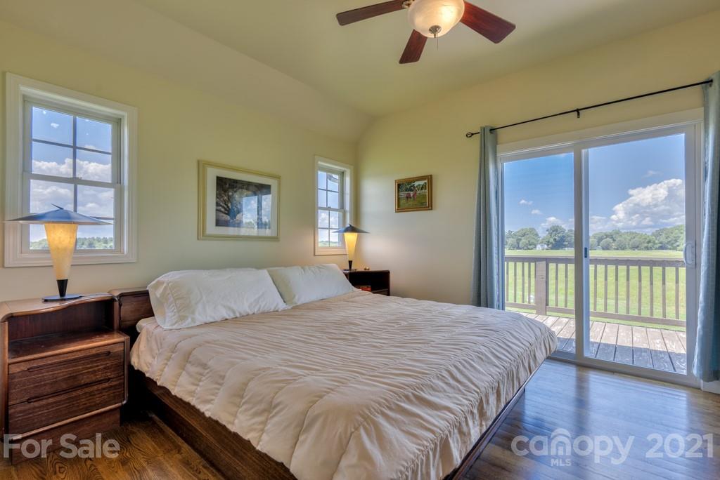 1365 Airport Road Rutherfordton, NC 28139 - Photo 22 of 32 a bedroom with a large bed and a chandelier