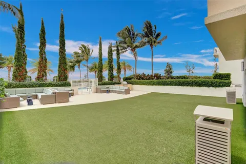 a swimming pool with outdoor seating