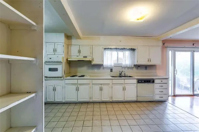 a kitchen with stainless steel appliances granite countertop a sink and cabinets