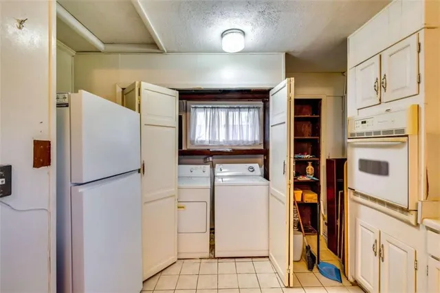 a kitchen with stainless steel appliances a refrigerator sink and cabinets