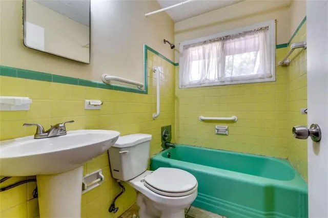 a bathroom with a sink a toilet and a bathtub