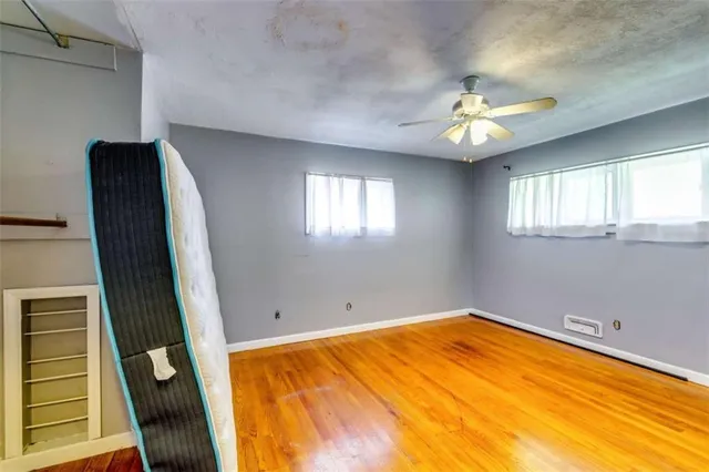 wooden floor in an empty room with a window