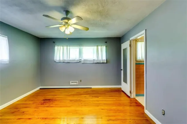 a view of a livingroom with a ceiling fan and window