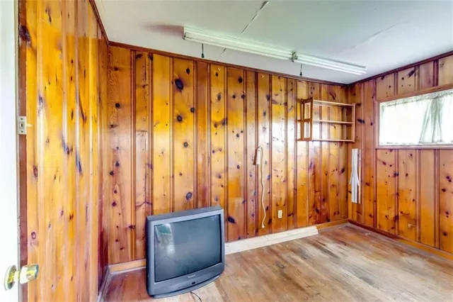 a view of an entryway with a window and a bath tub