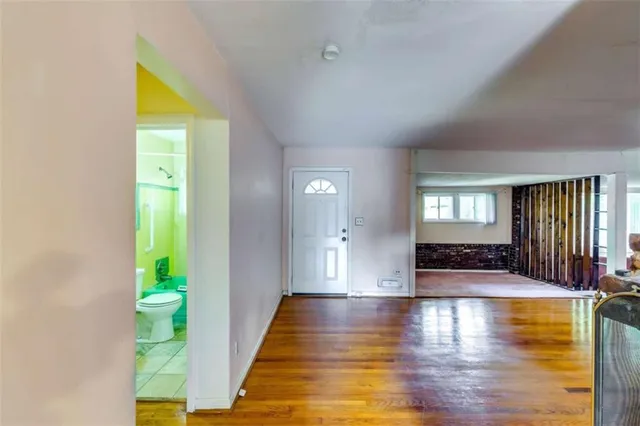 a view of an entryway with wooden floor