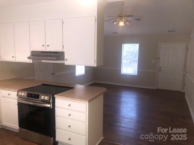 5904 White Cliffs Drive Monroe, NC 28110 - Photo 4 of 16 a kitchen with granite countertop a stove a sink and a microwave