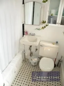 a bathroom with a sink toilet and mirror