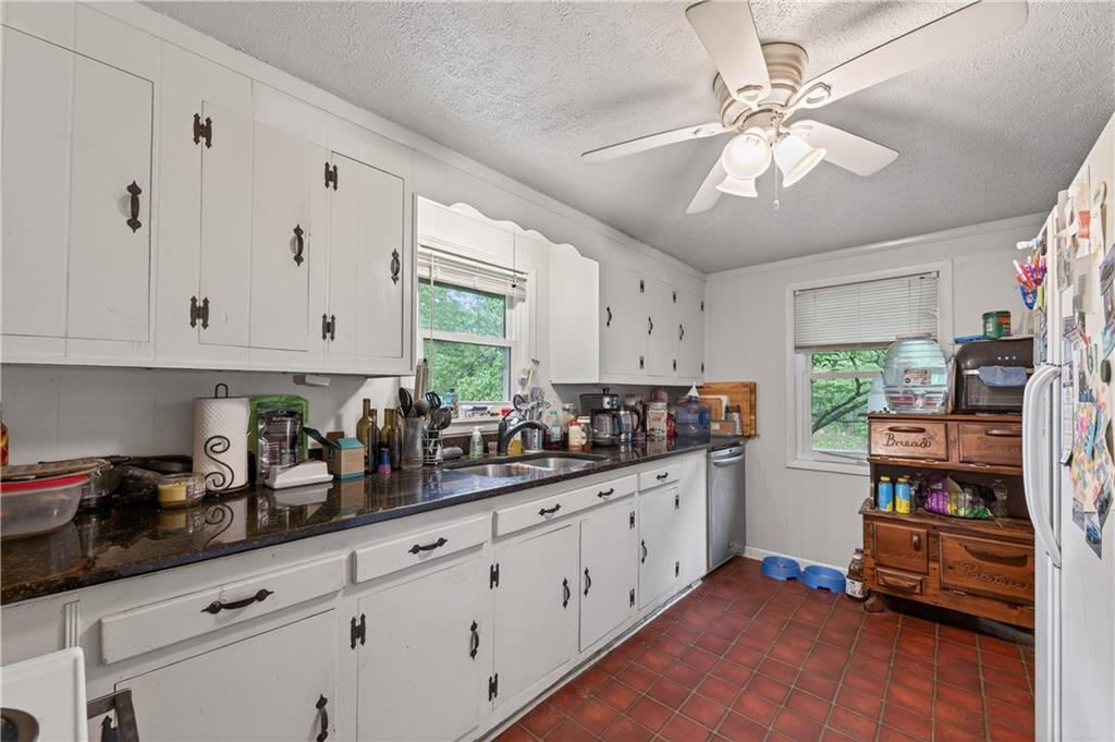 4399 Highway 411 Rydal, GA 30171 - Photo 4 of 37 a kitchen with stainless steel appliances sink cabinets and window