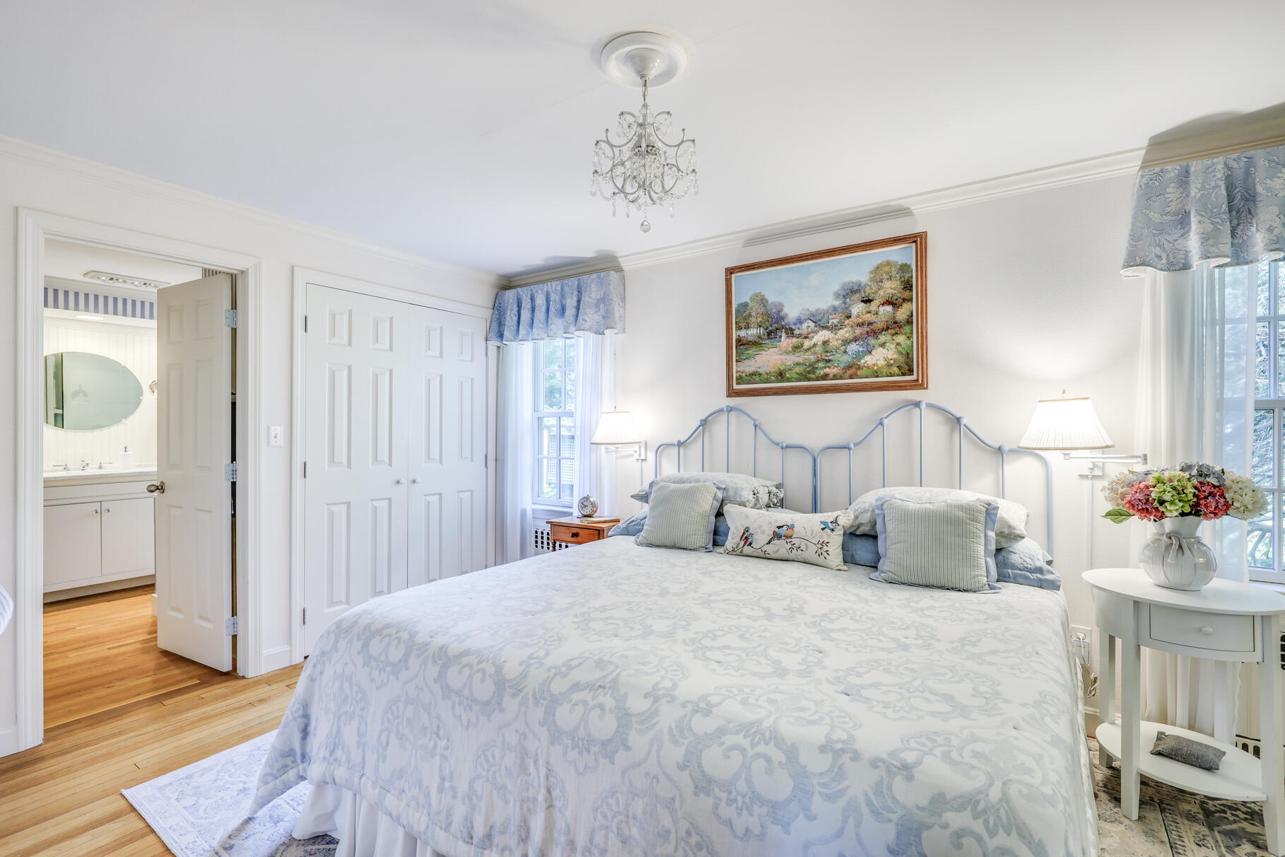 49 Fire Station Road Osterville, MA 02655 - Photo 21 of 32 a bedroom with a bed and a chandelier
