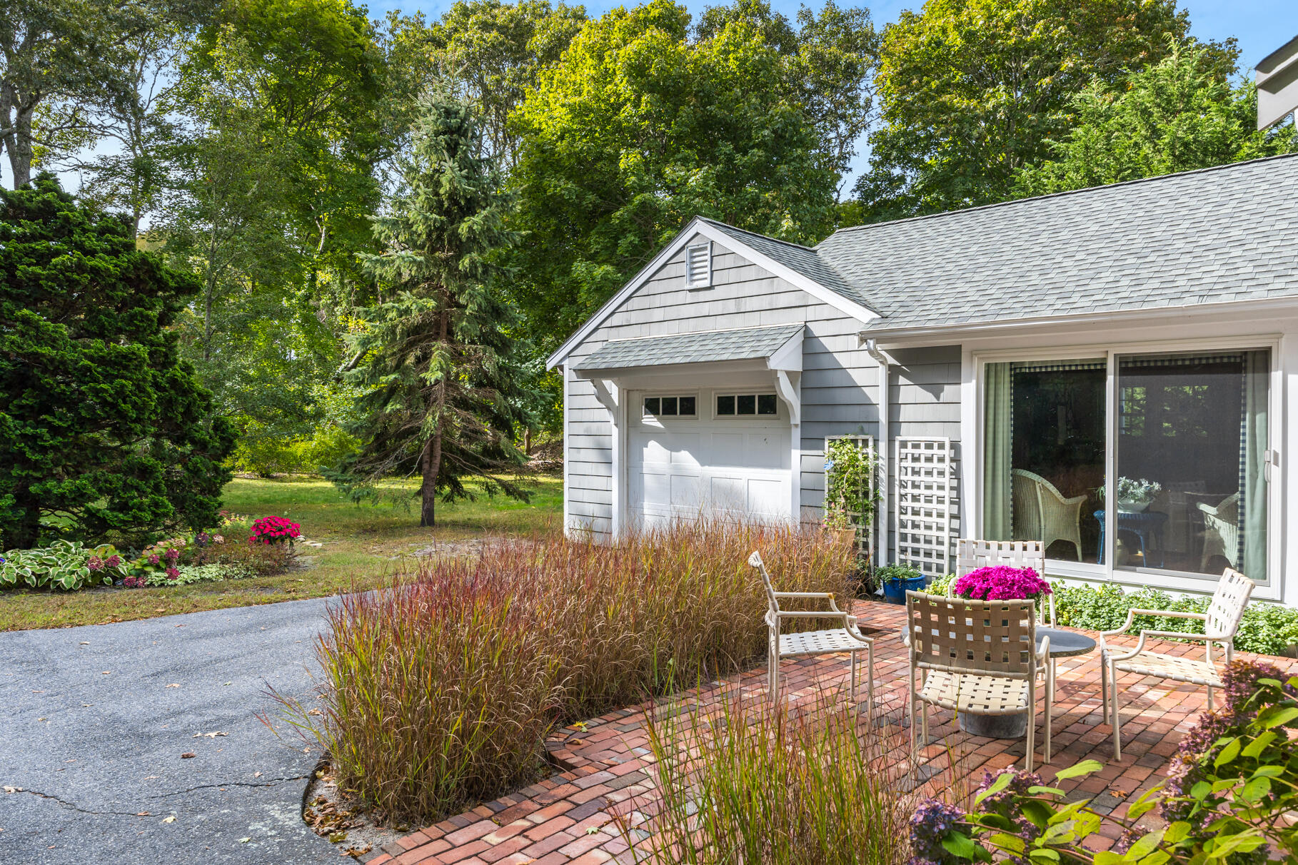 49 Fire Station Road Osterville, MA 02655 - Photo 27 of 32 a view of a patio with table and chairs and potted plants