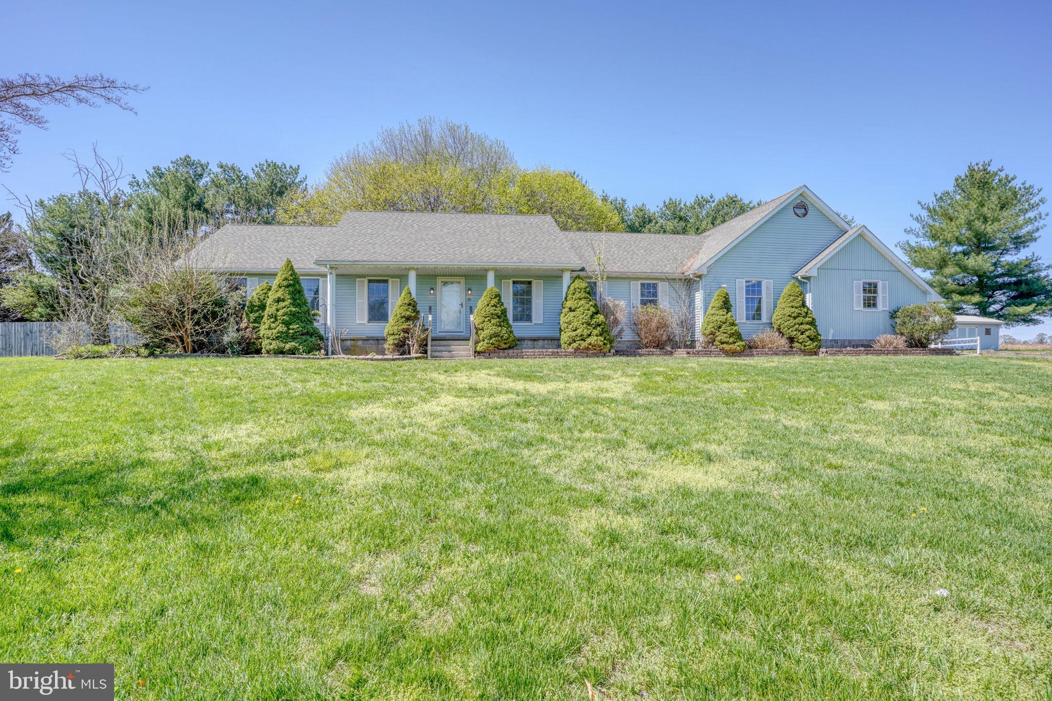 Charming home on lush green grounds.