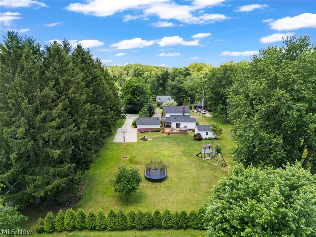 5983 Kungle Road Clinton, OH 44216 - Photo 26 of 29 Expansive green lawn with mature perimeter trees, a paved driveway