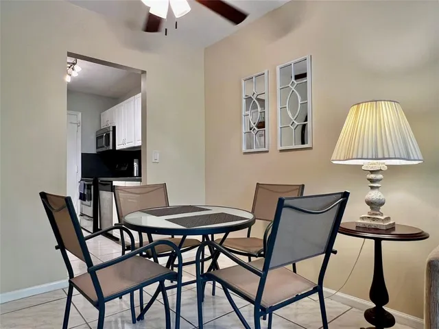 a view of a dining room with furniture and a lamp