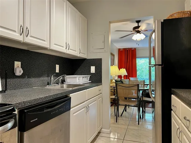 a kitchen with appliances cabinets and furniture