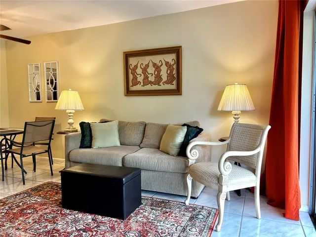 a living room with furniture and a lamp