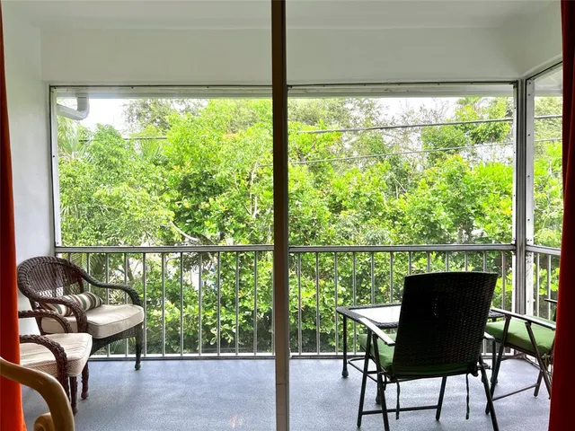 a view of a chairs and table in a balcony