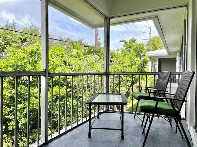 a view of a chairs and table in the balcony