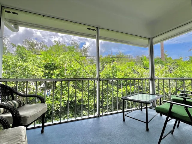 a view of a room with a furniture and a porch