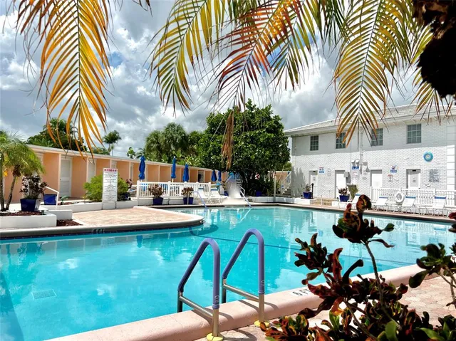 a view of swimming pool with outdoor seating and plants