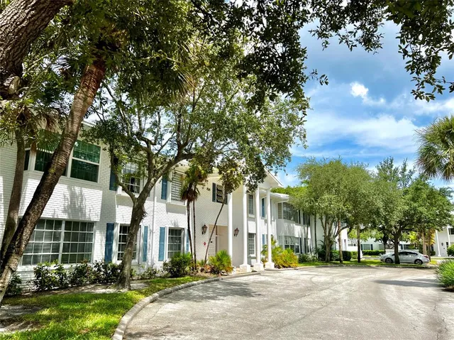 front view of a building with a tree