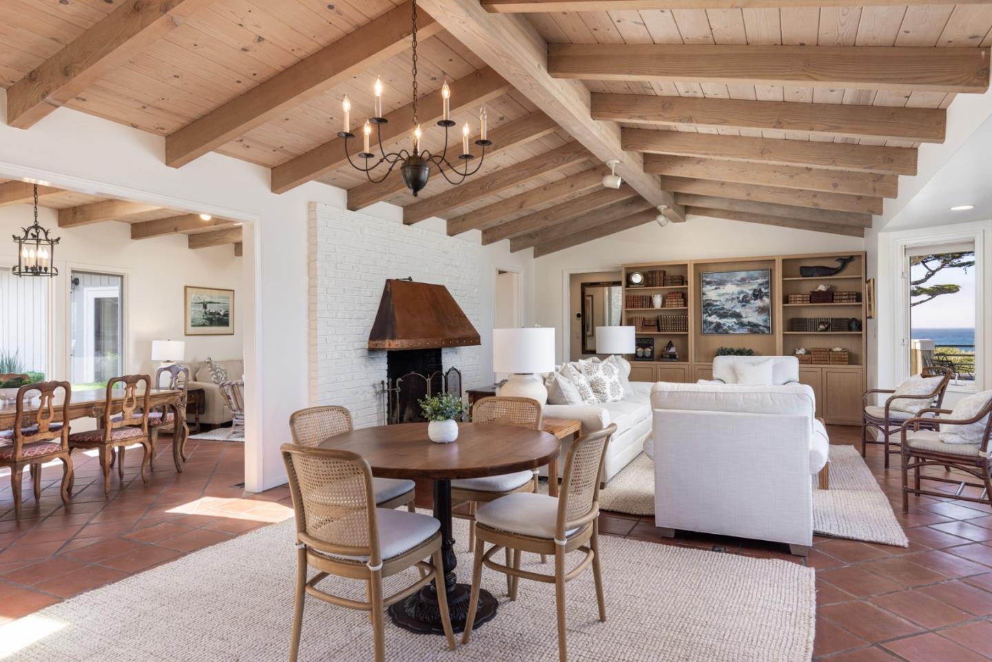26177 Scenic Road Carmel, CA 93923 - Photo 9 of 30 a dining room with furniture a chandelier and wooden floor