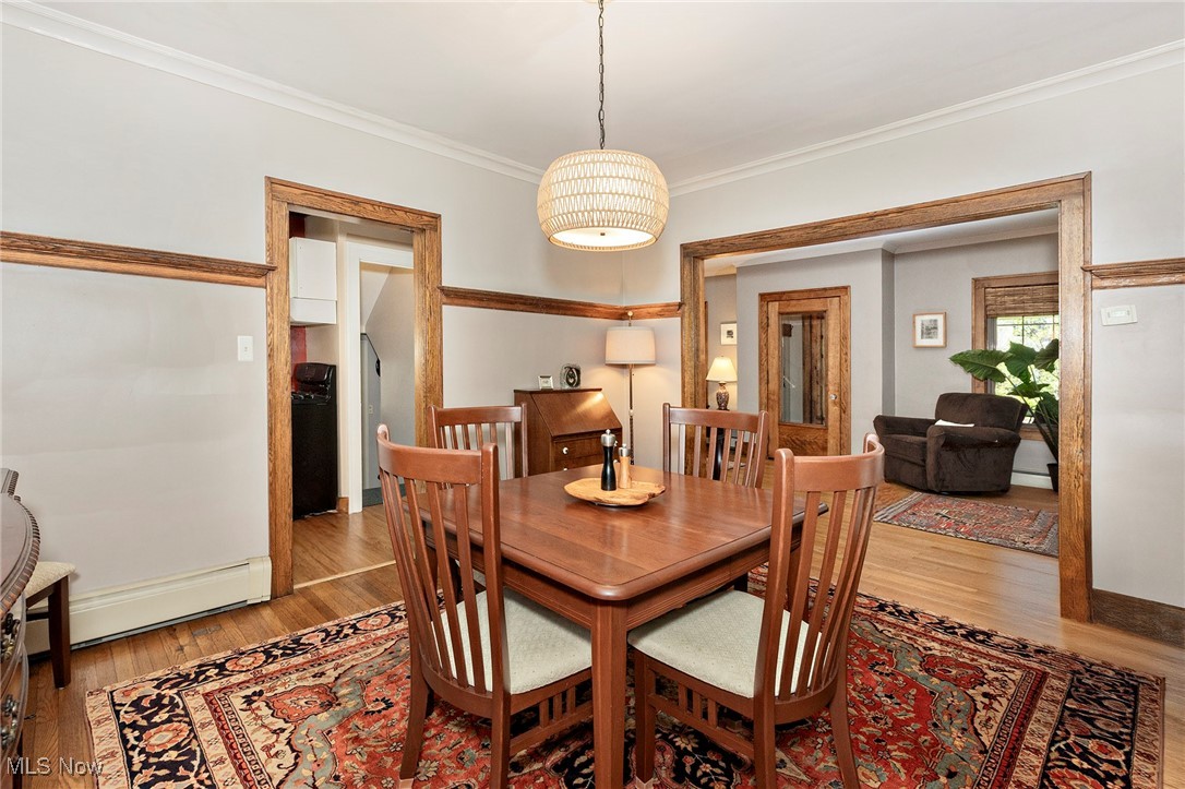 2985 Coleridge Road Cleveland, OH 44118 - Photo 16 of 46 Dining space with a baseboard heating unit, crown molding, and light wood finished floors