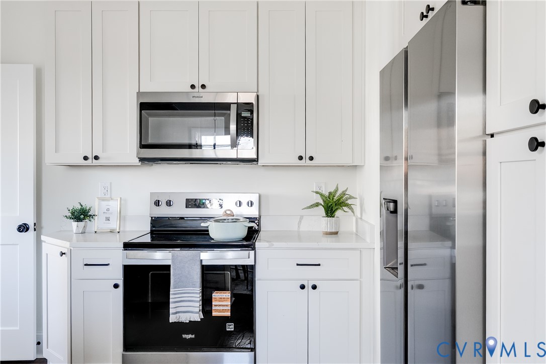 2207 Rawlings Street Henrico, VA 23231 - Photo 8 of 28 a kitchen with stainless steel appliances white cabinets and a refrigerator