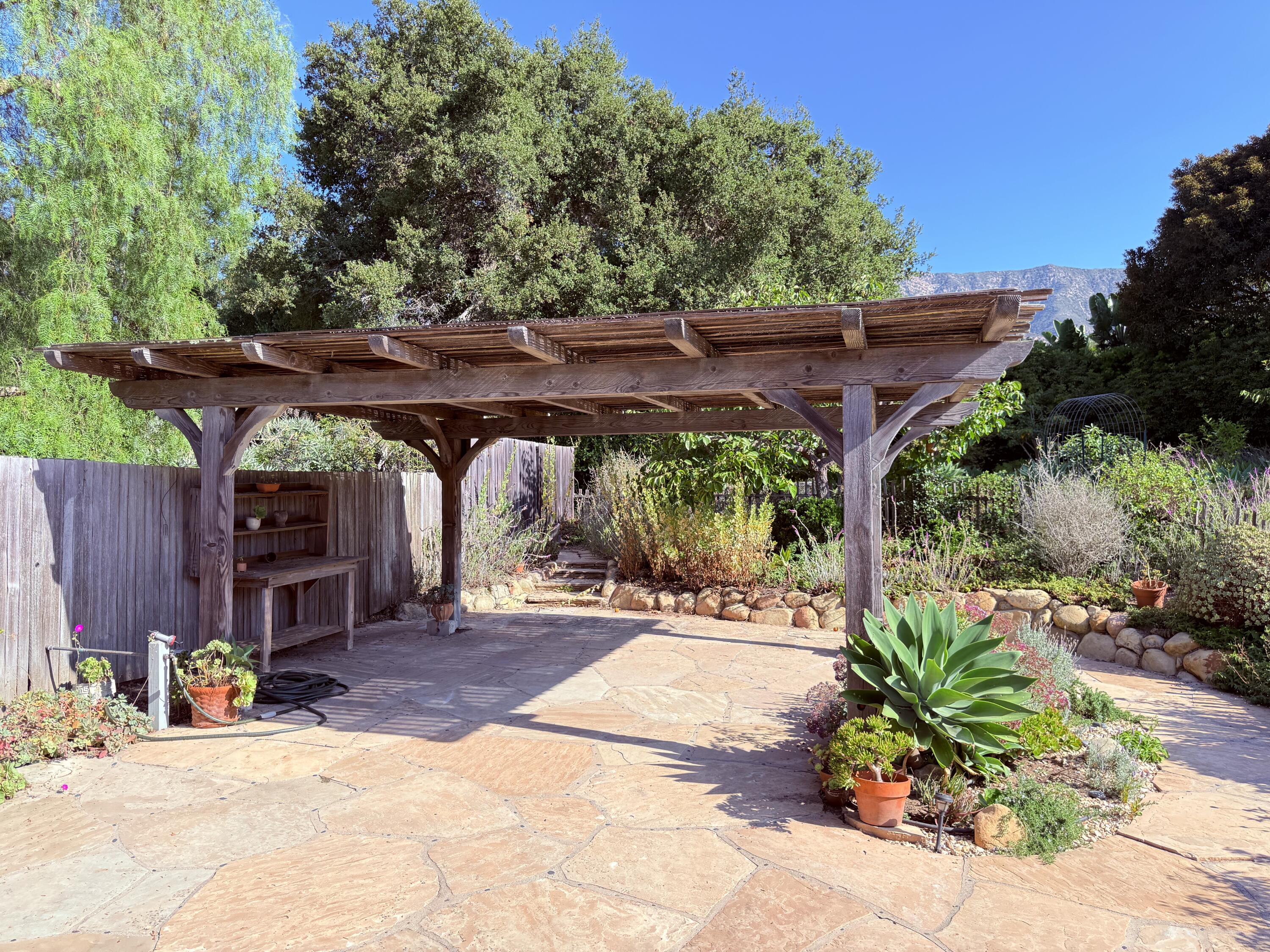 1747 Glen Oaks Drive Montecito, CA 93108 - Photo 22 of 24 a patio with wooden table and chairs