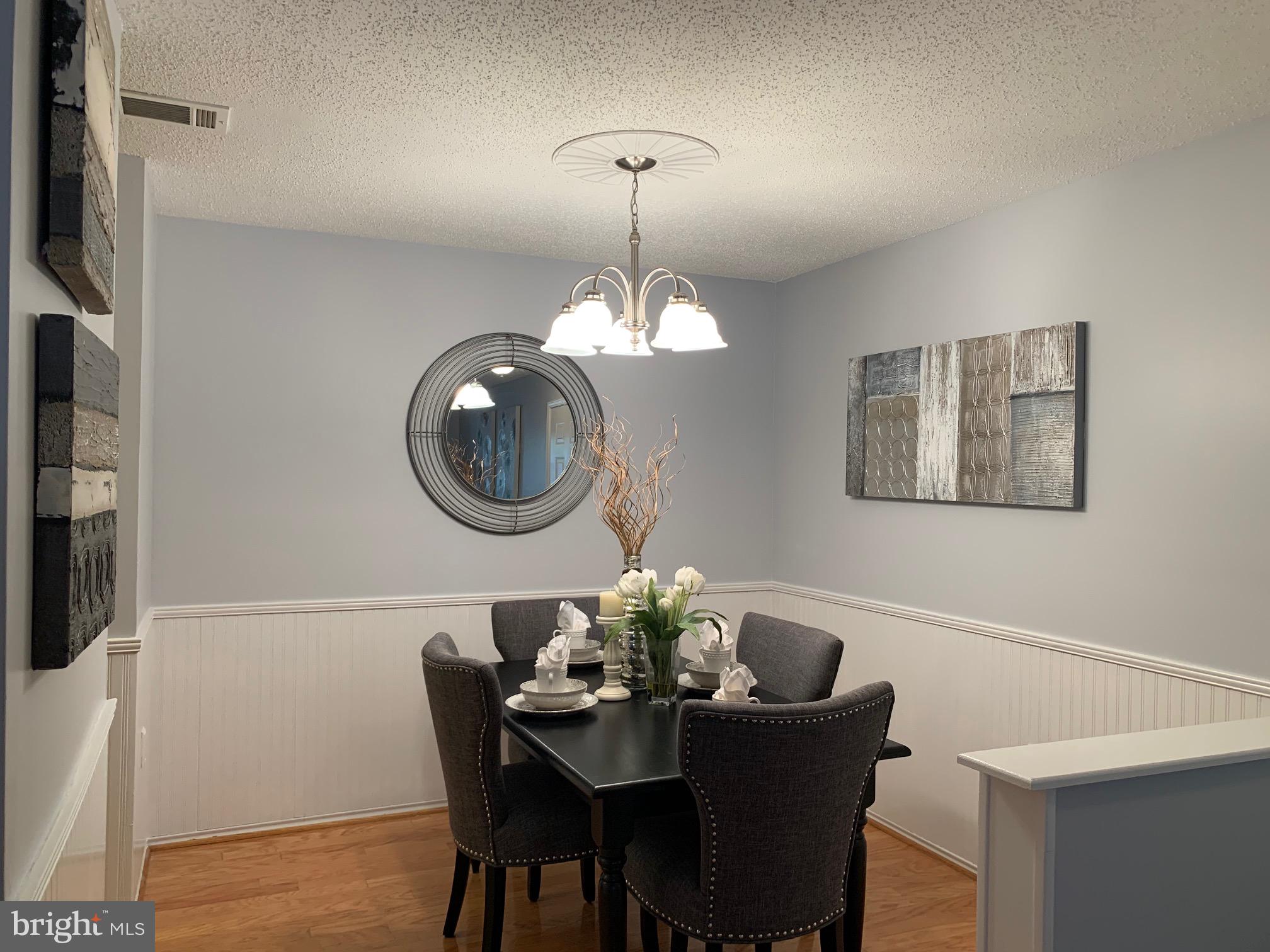 20960 Timber Ridge Terrace, Unit 101 Ashburn, VA 20147 - Photo 9 of 22 Dining room with Wainscotting