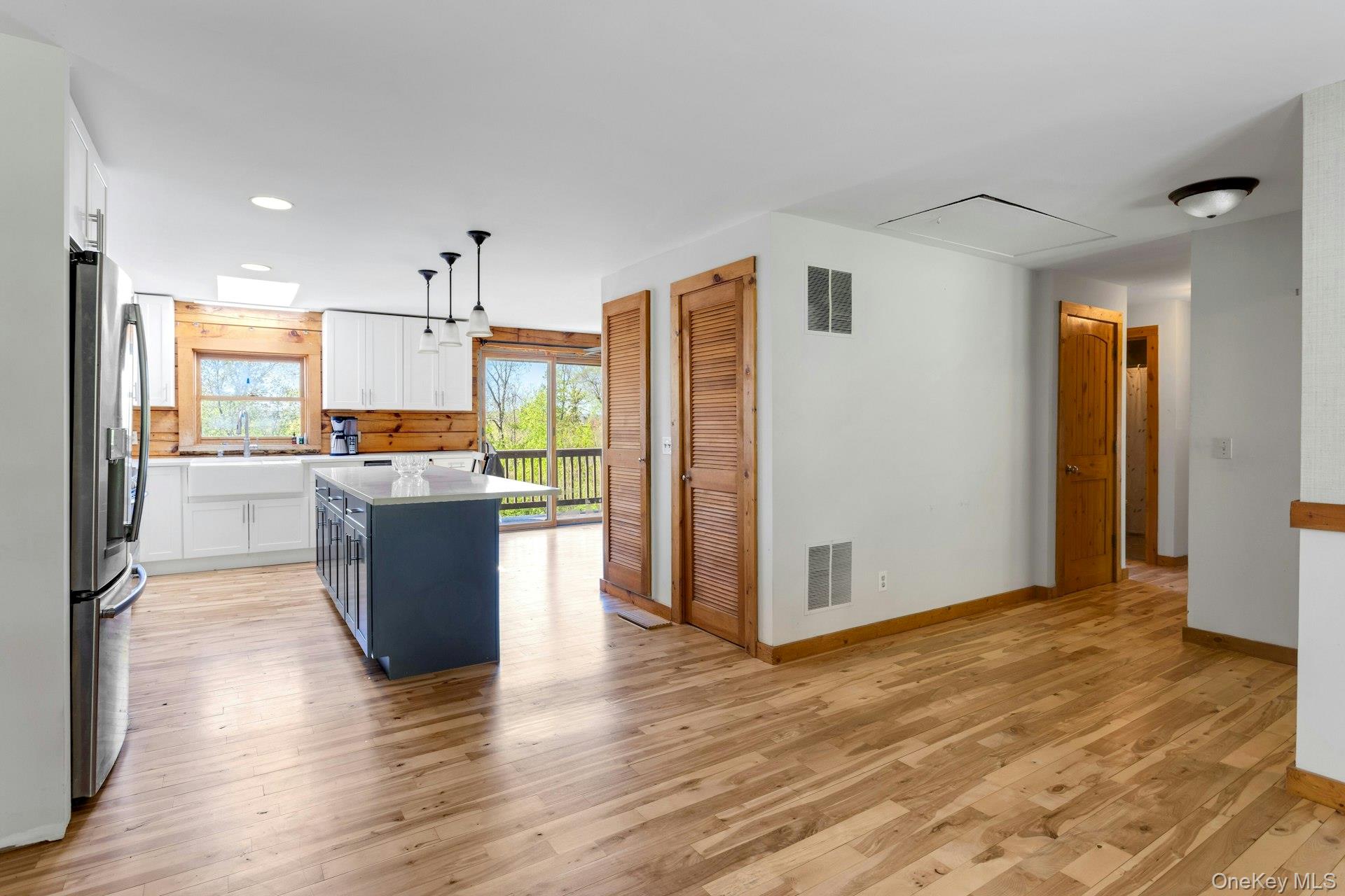 354 Sunset Hill Road East Fishkill, NY 12524 - Photo 8 of 31 an open kitchen with wooden floor and refrigerator
