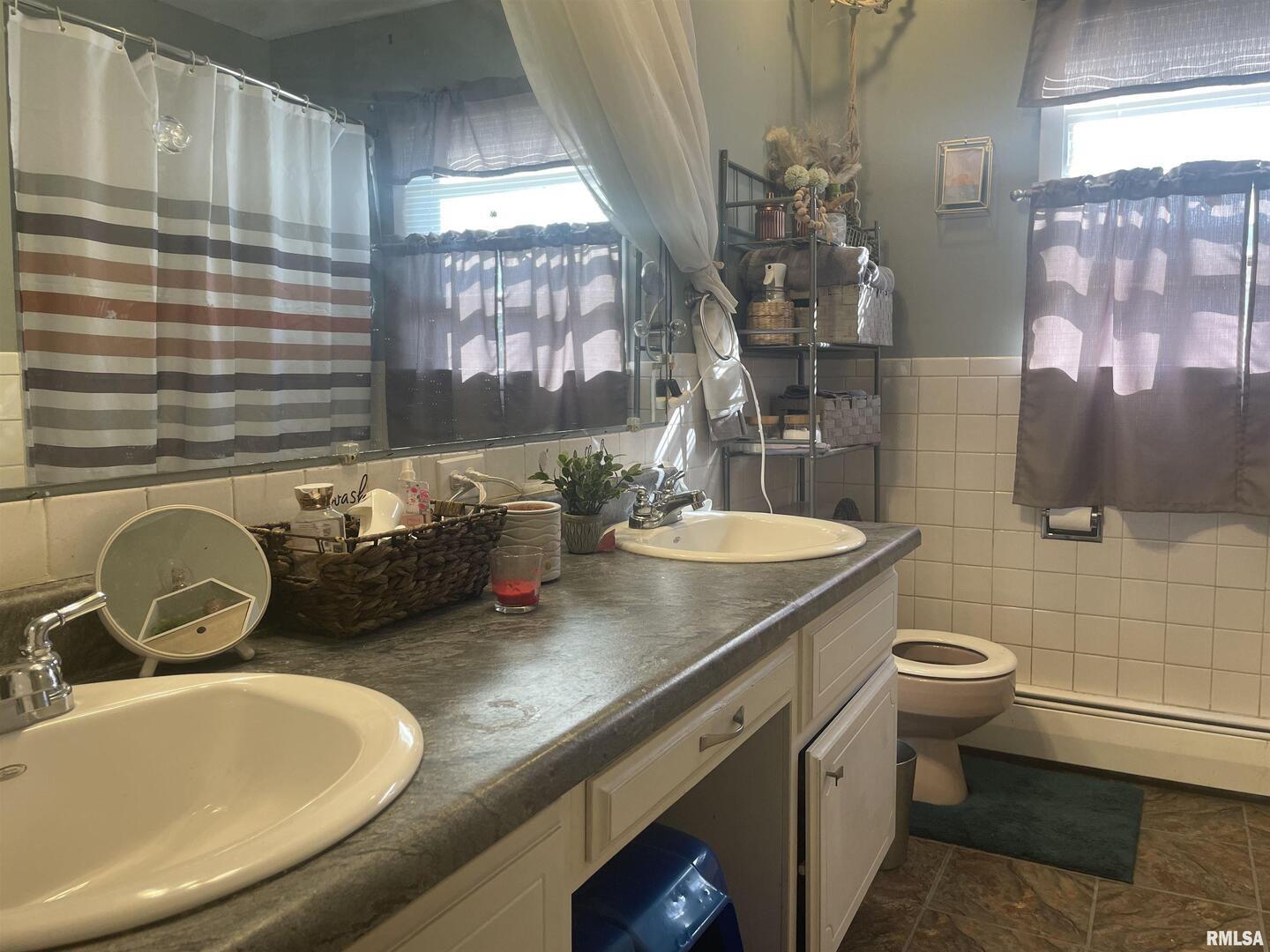 217 Apple Lane Anna, IL 62906 - Photo 23 of 39 a bathroom with a granite countertop double vanity and a mirror