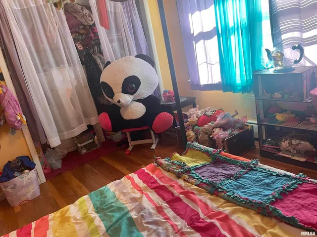 a bedroom with a bed and a mirror