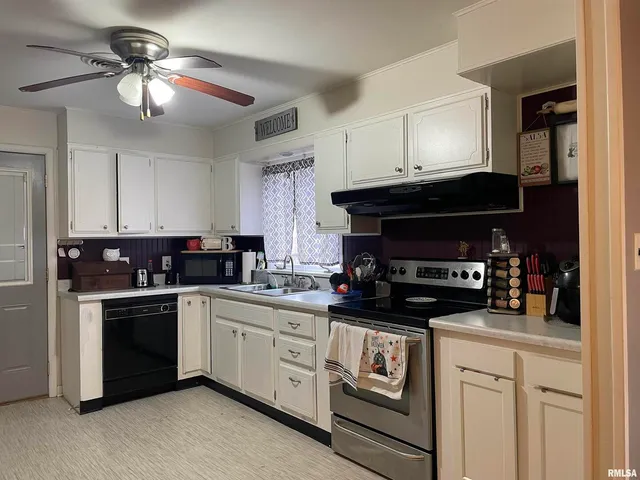 a kitchen with cabinets and stainless steel appliances