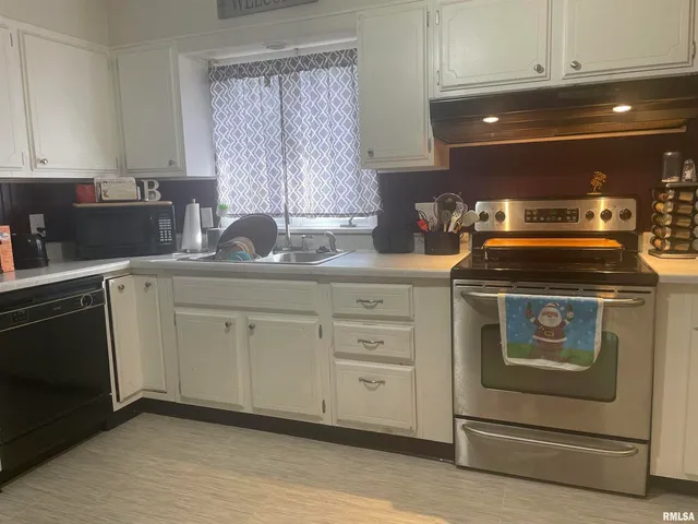 a kitchen with a stove and cabinets
