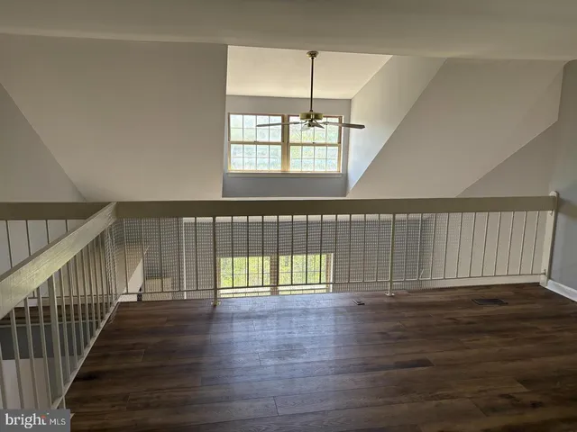 a view of an entryway with wooden floor