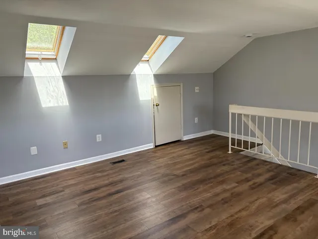 a view of roof deck with wooden floor and fence