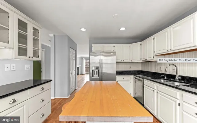 a kitchen with granite countertop a stove and cabinets