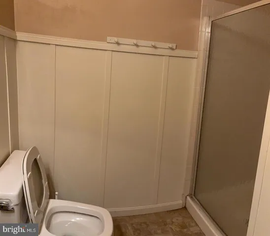 a bathroom with a toilet and a shower