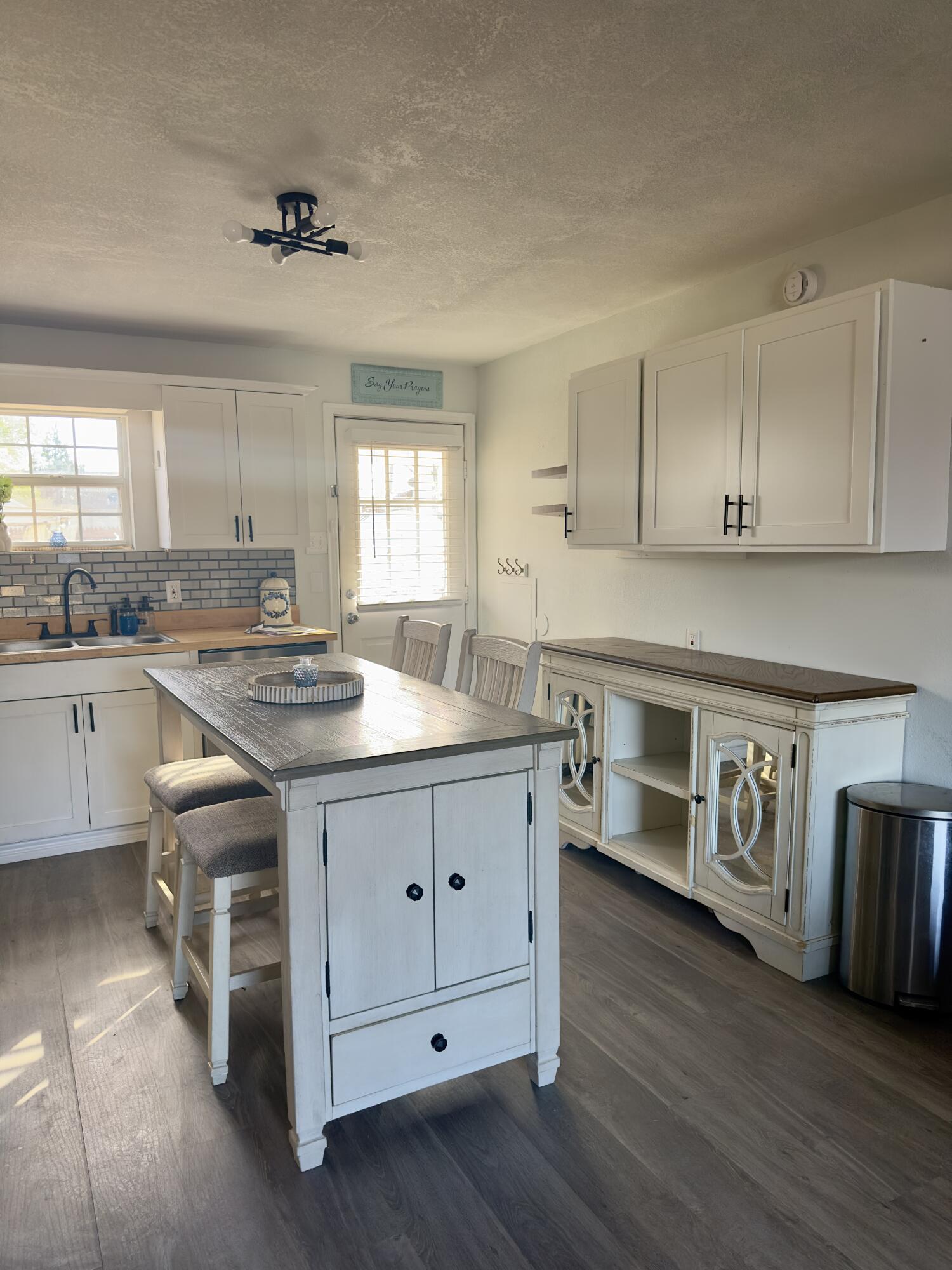 4807 39th Street Lubbock, TX 79414 - Photo 13 of 29 a kitchen with stainless steel appliances granite countertop a sink cabinets and wooden floor
