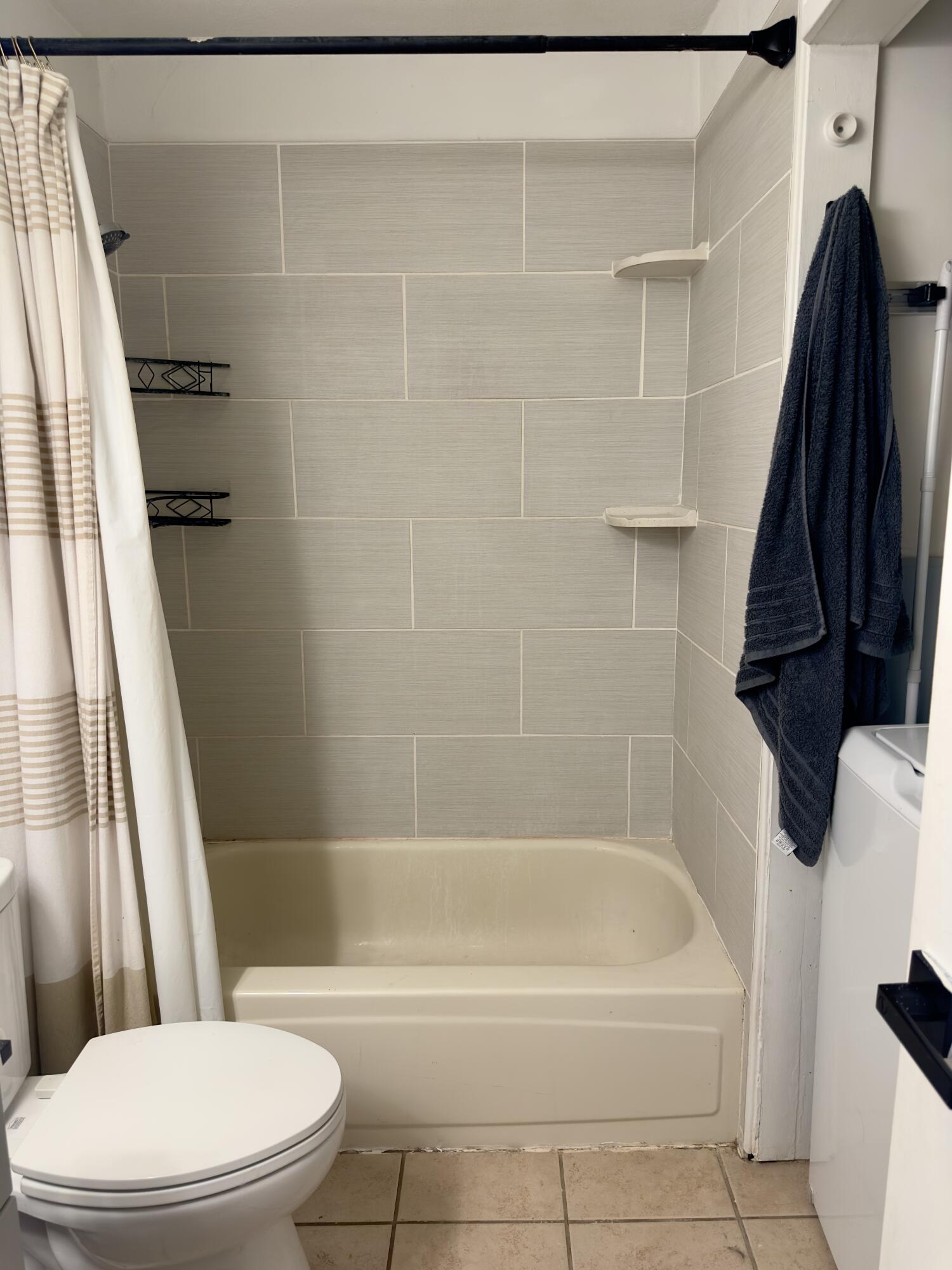 4807 39th Street Lubbock, TX 79414 - Photo 18 of 29 a white bath tub sitting next to a white toilet and sink