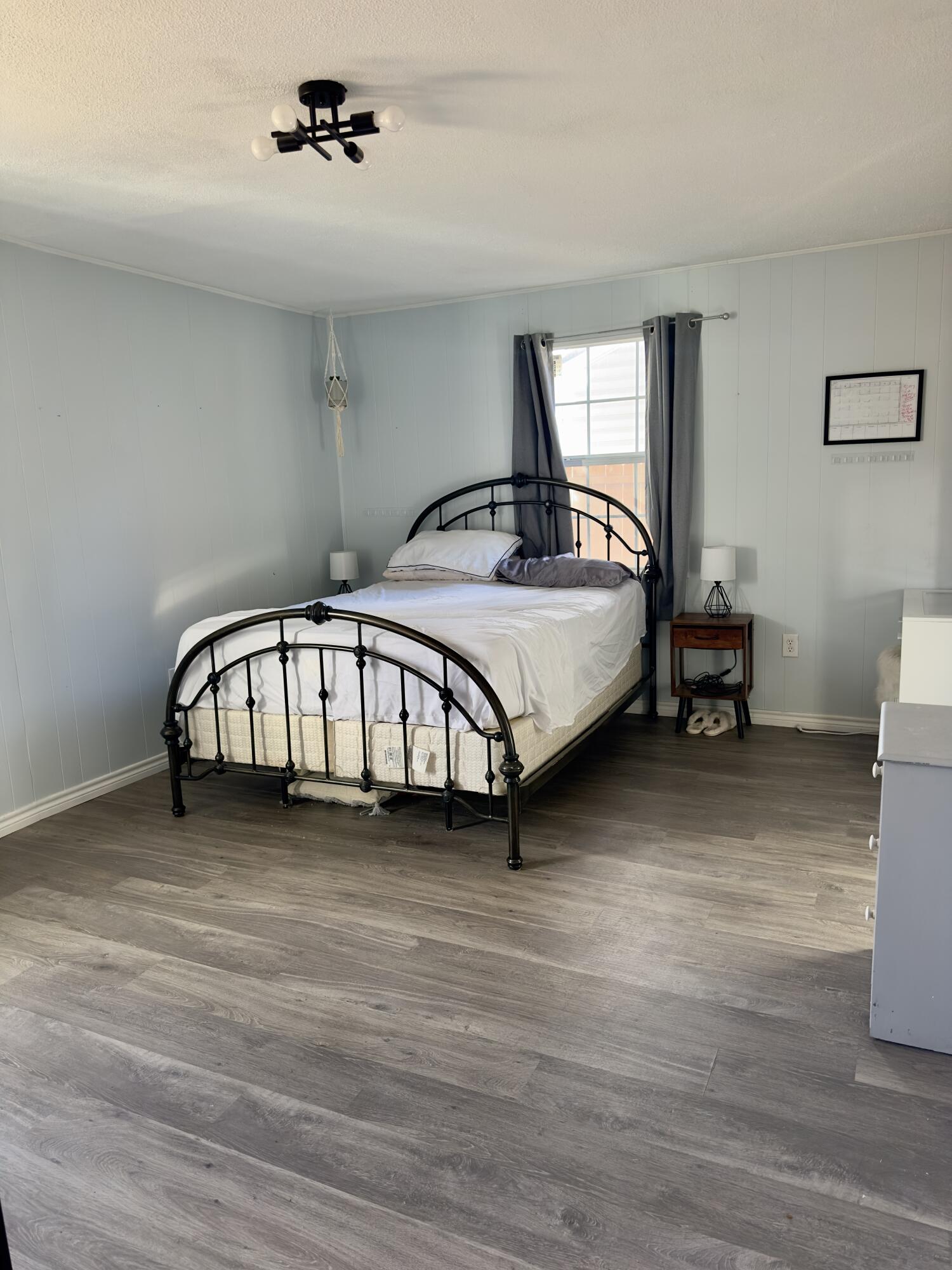 4807 39th Street Lubbock, TX 79414 - Photo 20 of 29 a spacious bedroom with a bed and a table