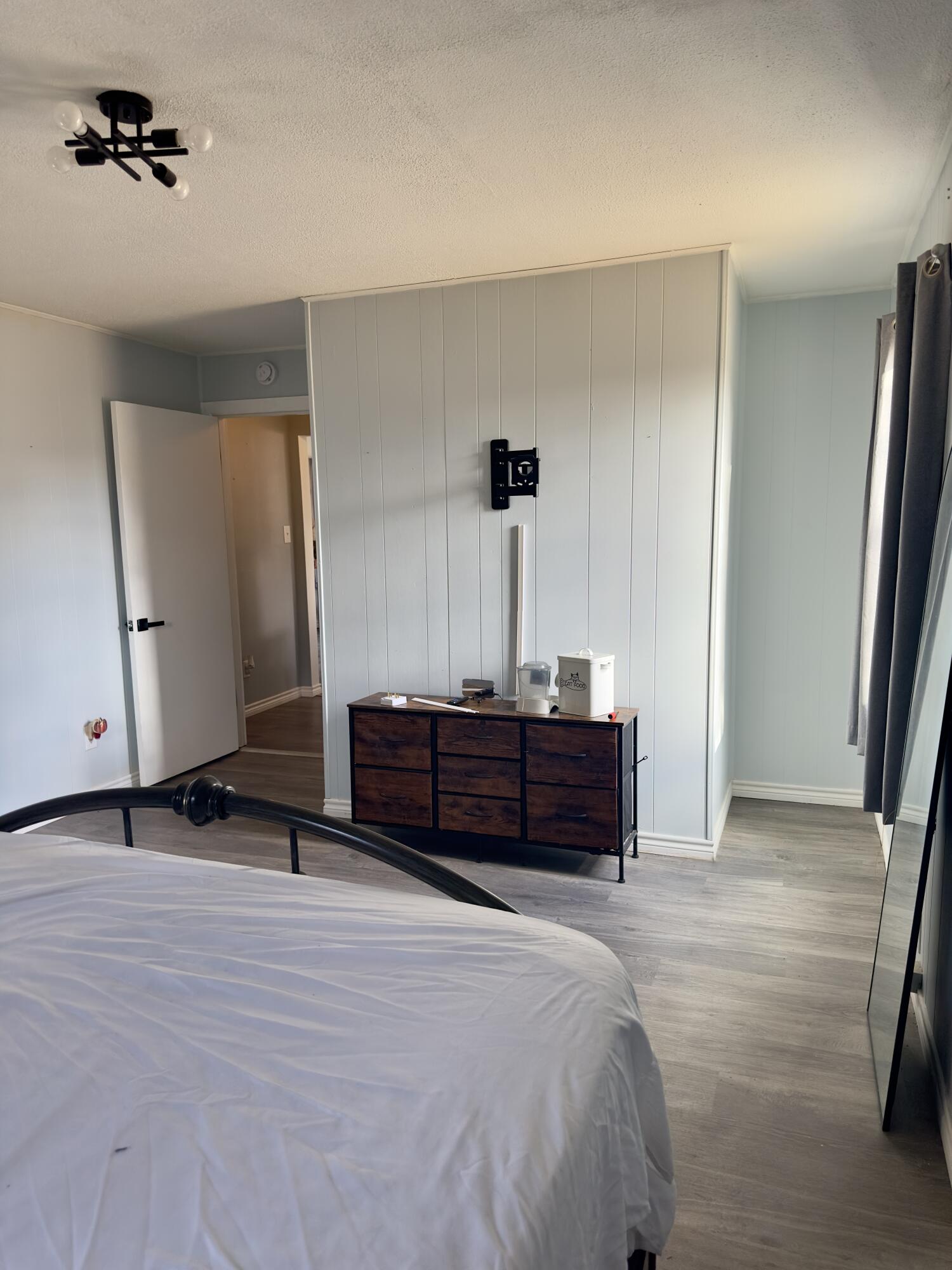 4807 39th Street Lubbock, TX 79414 - Photo 22 of 29 a bedroom with a bed and wooden floor