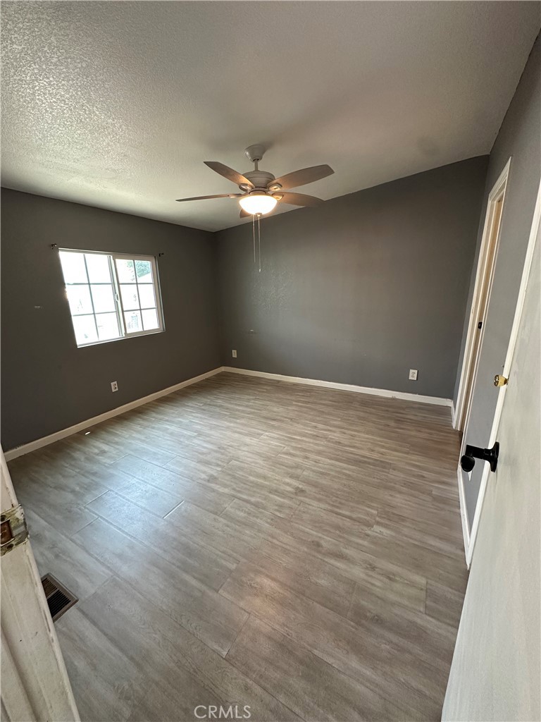 3825 Crestmore Road, Unit 414 Riverside, CA 92509 - Photo 11 of 31 wooden floor in an empty room with a window