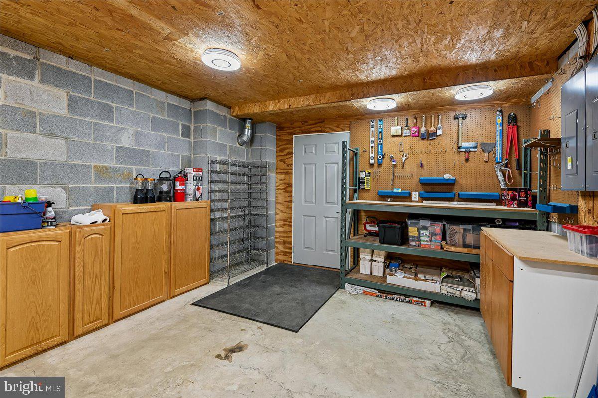 3633 Patuxent River Road Davidsonville, MD 21035 - Photo 64 of 85 Utility Room with Workbench and Wine Storage Racks
