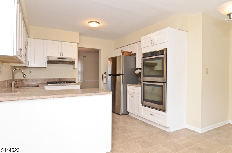 19 Jamestown Road Belle Mead, NJ 08502 - Photo 5 of 22 a kitchen with stainless steel appliances kitchen island granite countertop a refrigerator and a sink