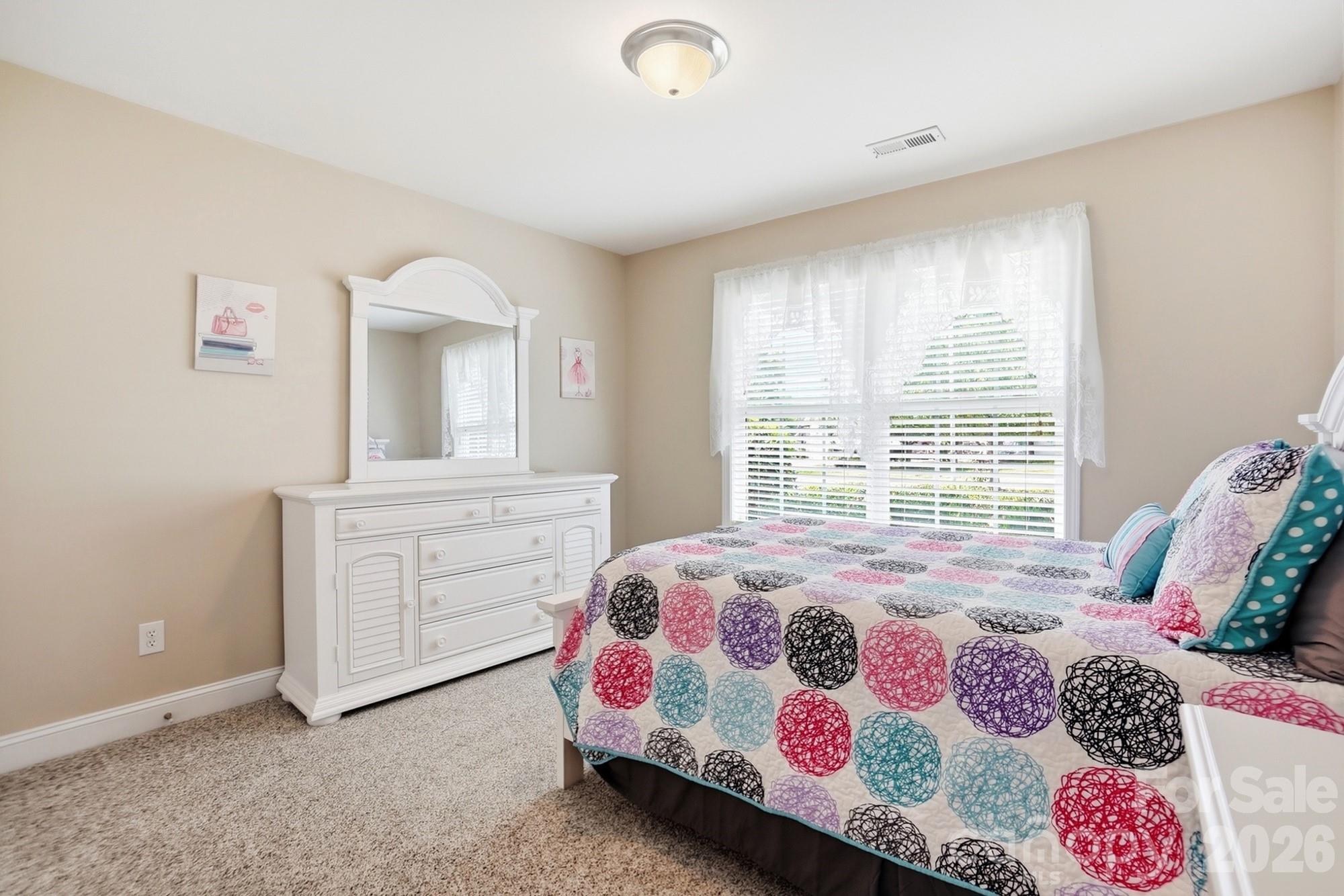 3324 Muddy Creek Road Midland, NC 28107 - Photo 35 of 46 a bedroom with a bed and a dresser