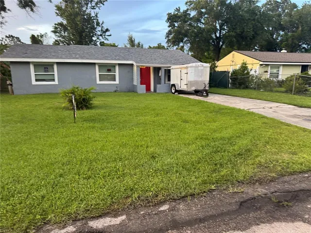 a front view of house with yard and green space