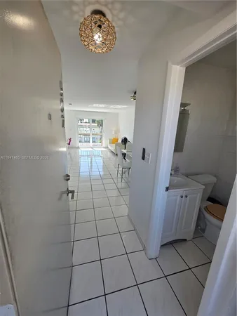 a kitchen with a refrigerator and a stove top oven